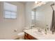 Well-lit half bathroom with a single vanity and a decorative mirror at 7579 Harwich Bay Ave, Las Vegas, NV 89179