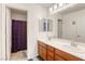 A bright bathroom has double sinks and plenty of storage at 7579 Harwich Bay Ave, Las Vegas, NV 89179