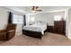 Bedroom featuring a comfortable bed, wooden furniture, and a ceiling fan at 7579 Harwich Bay Ave, Las Vegas, NV 89179