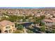 Aerial of the community entrance with decorative landscaping, iron gate, and desert surroundings at 7579 Harwich Bay Ave, Las Vegas, NV 89179