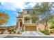 This two-story home has a two-car garage, front yard, and a balcony over the front door at 7579 Harwich Bay Ave, Las Vegas, NV 89179