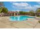 An outdoor pool with a decorative fence and a covered lounge area at 7579 Harwich Bay Ave, Las Vegas, NV 89179