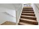 Carpeted staircase with white handrail leading to the upper level at 7579 Harwich Bay Ave, Las Vegas, NV 89179