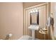 Charming half-bathroom featuring a pedestal sink and decorative accents at 10234 Renae Nicole Ct, Las Vegas, NV 89183