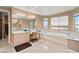 Luxurious bathroom with soaking tub, vanity area, and ample natural light at 10234 Renae Nicole Ct, Las Vegas, NV 89183