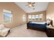 Spacious bedroom with a ceiling fan and large window offering ample natural light at 10234 Renae Nicole Ct, Las Vegas, NV 89183