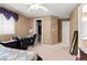 Cozy bedroom with a neutral color scheme, carpeting, desk, and closet at 10234 Renae Nicole Ct, Las Vegas, NV 89183