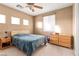 Bedroom with a ceiling fan, a large bed and a light wood dresser at 10234 Renae Nicole Ct, Las Vegas, NV 89183