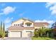 Elegant two-story home featuring a three-car garage and manicured landscaping with palm trees at 10234 Renae Nicole Ct, Las Vegas, NV 89183