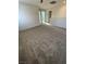 Upper level bonus room with neutral carpeting and multiple bedroom entrances at 11177 Deluna St, Las Vegas, NV 89141