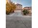 Two-story home with a two-car garage and a long driveway on a sunny day at 11177 Deluna St, Las Vegas, NV 89141