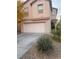 Two-story house with a two-car garage, complemented by desert landscaping at 11177 Deluna St, Las Vegas, NV 89141