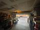 Tidy garage with shelving, storage, and an open door to the driveway at 11177 Deluna St, Las Vegas, NV 89141