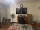 Cozy living room with dark wood floors, an area rug, and a television at 11177 Deluna St, Las Vegas, NV 89141