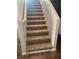 Carpeted staircase with white walls and baseboards leading to the upper level of the home at 11177 Deluna St, Las Vegas, NV 89141