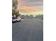 This image shows the street view of the home during a lovely sunset at 11177 Deluna St, Las Vegas, NV 89141