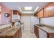 Efficient kitchen featuring granite countertops, wooden cabinetry, and stainless steel appliances under a skylight at 4200 S Valley View Blvd # 3030, Las Vegas, NV 89103