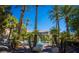 Serene community pool surrounded by lush tropical landscaping and towering palm trees at 4200 S Valley View Blvd # 3030, Las Vegas, NV 89103