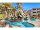 Community pool area featuring lush tropical landscaping and a relaxing rock waterfall feature at 4200 S Valley View Blvd # 3030, Las Vegas, NV 89103