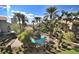 Aerial view of a stunning community pool surrounded by lush landscaping, lounge chairs, and palm trees at 4200 S Valley View Blvd # 3030, Las Vegas, NV 89103