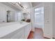 Bathroom vanity featuring double sinks, tile counters, and ample cabinet space at 5255 Dickens Dr # 0, Las Vegas, NV 89119