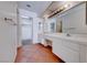 Bathroom vanity featuring double sinks, tile counters, and ample cabinet space at 5255 Dickens Dr # 0, Las Vegas, NV 89119