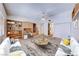 Bright living room featuring a ceiling fan, built-in desk, and neutral colored furniture at 5255 Dickens Dr # 0, Las Vegas, NV 89119