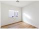 Cozy bedroom featuring hardwood floors, a window letting in natural light, and fresh paint at 7936 Pinnochio Ave, Las Vegas, NV 89131