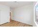 Bright bedroom with wood-look vinyl floors, a closet, and natural light from the window at 7936 Pinnochio Ave, Las Vegas, NV 89131