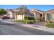 Single-Gathering home with desert landscaping, a two-car garage, and a red tiled roof at 7936 Pinnochio Ave, Las Vegas, NV 89131