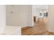 Hallway leading to the kitchen and backyard with light wood floors and white walls at 7936 Pinnochio Ave, Las Vegas, NV 89131