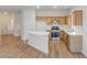 Bright kitchen featuring stainless steel appliances, wood cabinets, and an island with a white countertop at 7936 Pinnochio Ave, Las Vegas, NV 89131