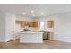 Bright kitchen featuring stainless steel appliances, wood cabinets, and an island with a white countertop at 7936 Pinnochio Ave, Las Vegas, NV 89131