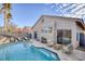 Inviting backyard oasis featuring a sparkling pool, lounge chairs, and a serene seating area at 7936 Pinnochio Ave, Las Vegas, NV 89131