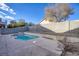 Backyard featuring a sparkling blue pool, a concrete patio, and a well-maintained block wall for privacy at 7936 Pinnochio Ave, Las Vegas, NV 89131