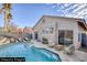 Staged backyard boasts a sparkling pool, lounge chairs, and patio seating, perfect for outdoor entertaining at 7936 Pinnochio Ave, Las Vegas, NV 89131