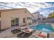 Backyard featuring a refreshing pool with lounge chairs, perfect for relaxation and outdoor enjoyment at 7936 Pinnochio Ave, Las Vegas, NV 89131