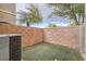 Small, grassy backyard with block wall and AC unit at 9790 Overlook Ridge Ave, Las Vegas, NV 89148