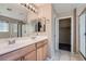 Bathroom with double sinks, wood cabinets and a shower at 9790 Overlook Ridge Ave, Las Vegas, NV 89148