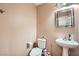 Small bathroom with pedestal sink and toilet at 9790 Overlook Ridge Ave, Las Vegas, NV 89148