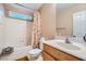 Bathroom with shower/tub, floral curtain, and wood vanity at 9790 Overlook Ridge Ave, Las Vegas, NV 89148