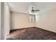 Spacious bedroom with ceiling fan and dark carpet at 9790 Overlook Ridge Ave, Las Vegas, NV 89148