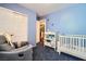 Charming bedroom with a crib, changing table, and double doors at 9790 Overlook Ridge Ave, Las Vegas, NV 89148