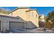 Tan two-story house with attached garage and landscaped walkway at 9790 Overlook Ridge Ave, Las Vegas, NV 89148