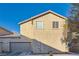 Tan two-story house with attached garage and desert landscaping at 9790 Overlook Ridge Ave, Las Vegas, NV 89148