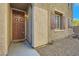 House exterior, showcasing a brown front door with sidelights and shutters at 9790 Overlook Ridge Ave, Las Vegas, NV 89148