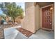 Dark brown front door with a decorative doormat at 9790 Overlook Ridge Ave, Las Vegas, NV 89148