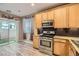 Bright kitchen features stainless steel appliances and granite countertops at 9790 Overlook Ridge Ave, Las Vegas, NV 89148