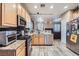 Open kitchen with granite counters and breakfast bar at 9790 Overlook Ridge Ave, Las Vegas, NV 89148