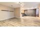 Open living area with wood-look floors, and a view of the kitchen at 9790 Overlook Ridge Ave, Las Vegas, NV 89148